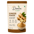 A 100g stand-up pouch of Damira by Gupta Ginger Powder, featuring a beige and brown design with an illustration of fresh ginger roots, green leaves, and a bowl of the ground ginger powder.