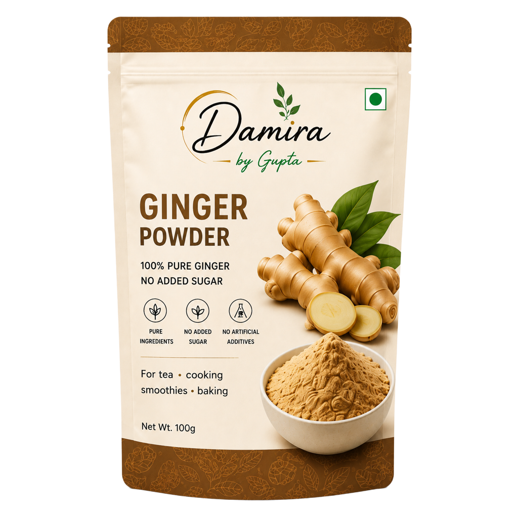 A 100g stand-up pouch of Damira by Gupta Ginger Powder, featuring a beige and brown design with an illustration of fresh ginger roots, green leaves, and a bowl of the ground ginger powder.